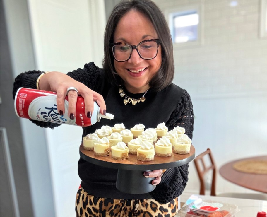 adding whipped cream to cheesecake bites 