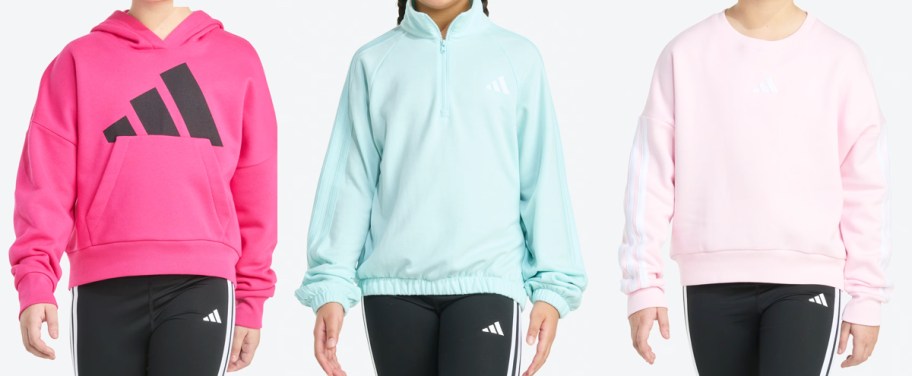 three girls in pink and blue adidas sweatshirts