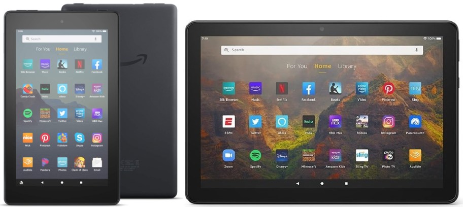 Three black Amazon Fire tablets: one in portrait orientation and a larger one in landscape orientation displaying their home screens, along with the back panel of a third tablet showing the Amazon logo.