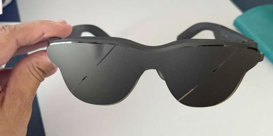 hand holding black glasses