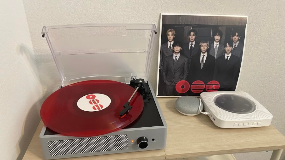 record player on table with red vinyl