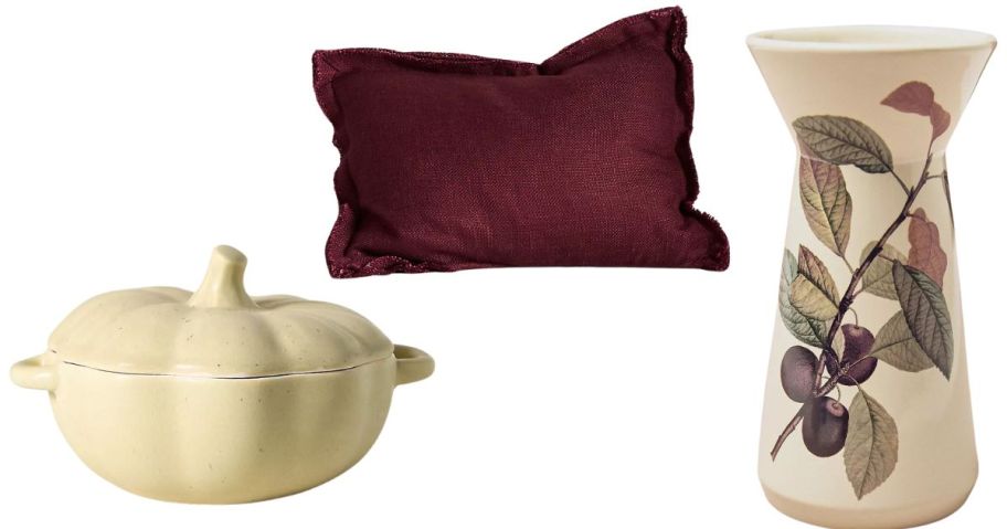 a pumpkin Cocotte, a pillow, and a vase