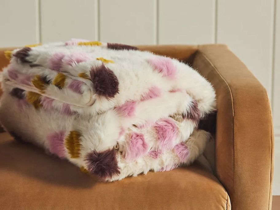 Anthropologie Dottie Jacquard Patterned Faux Fur Throw Blanket folded on couch