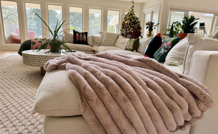 light pink faux fur blanket on couch