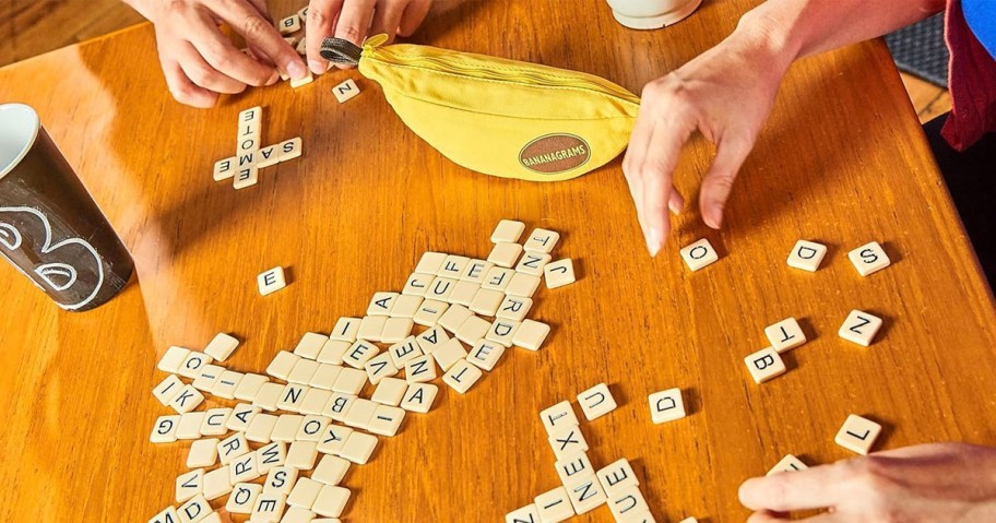 hands playing bananagrams game on table