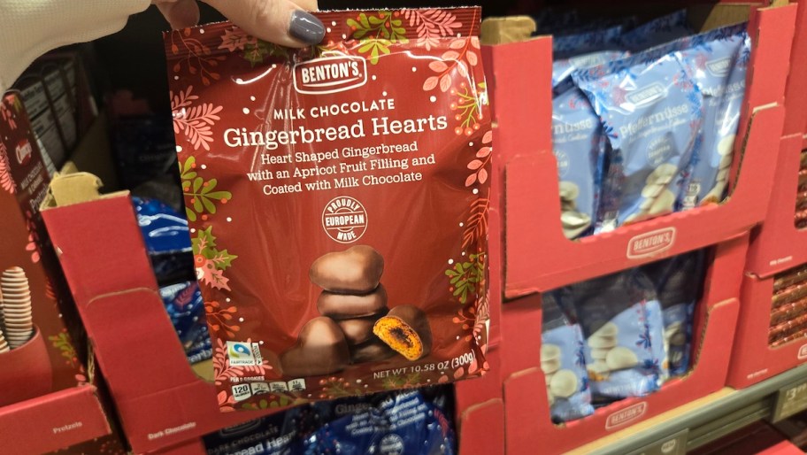 hand holding gingerbread hearts bag in store