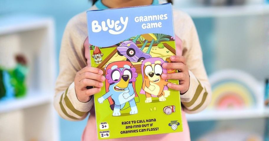 kid holding bluey grannies game box
