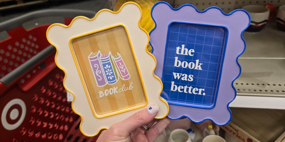 hand holding two book frames 