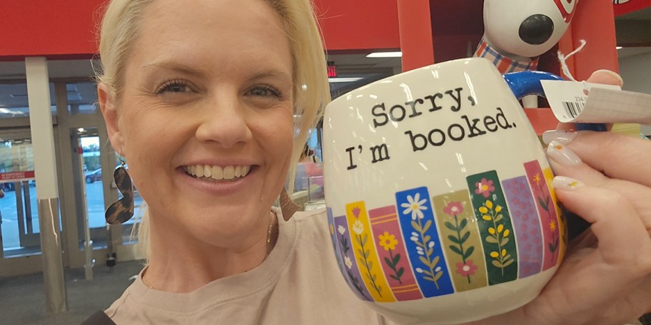 woman holding book mug 