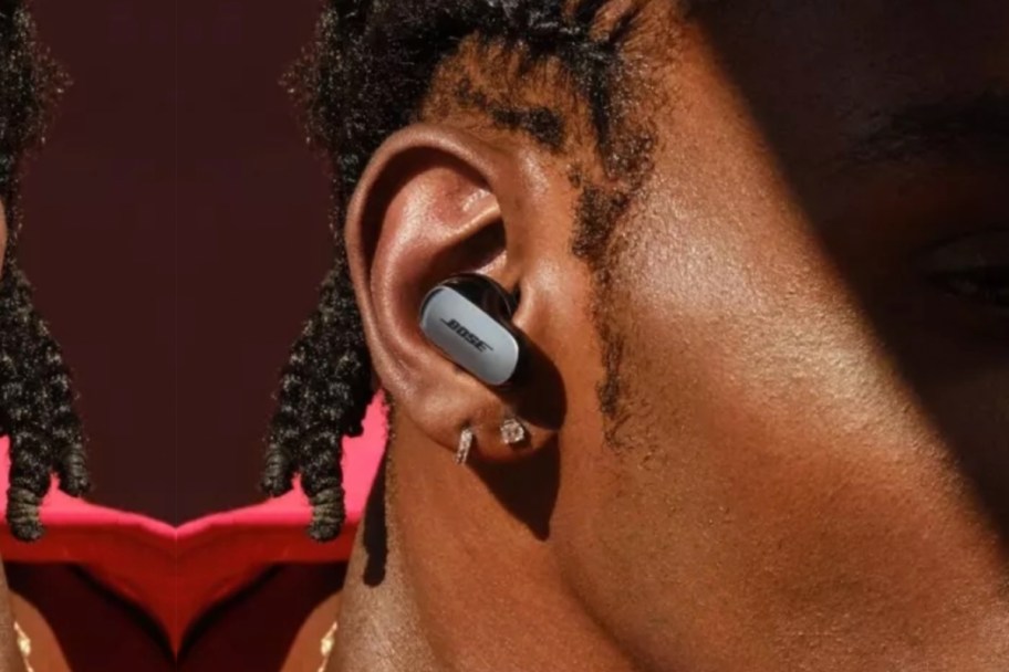 silver and black earbud in ear