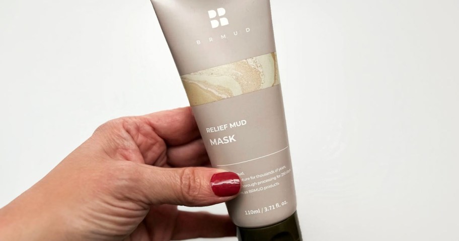 hand holding brmud mud mask 