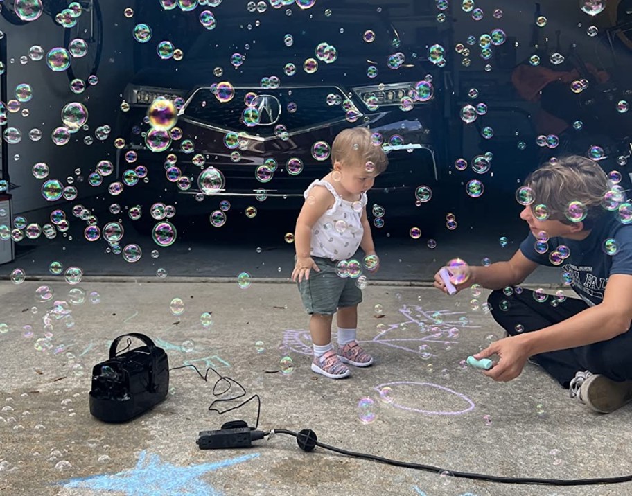 baby playing in bubbles outside