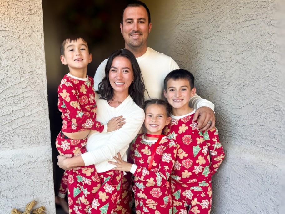 A family taking a photo in matching Christmas pajamas