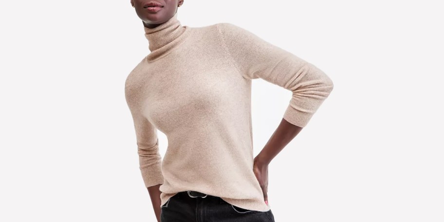 woman wearing tan sweater