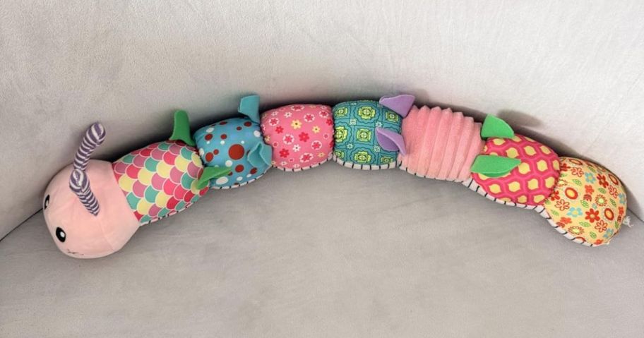 musical caterpillar toy on bassinet