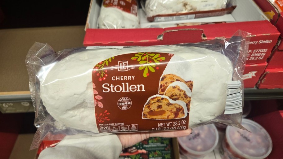 hand holding a cherry stollen in package