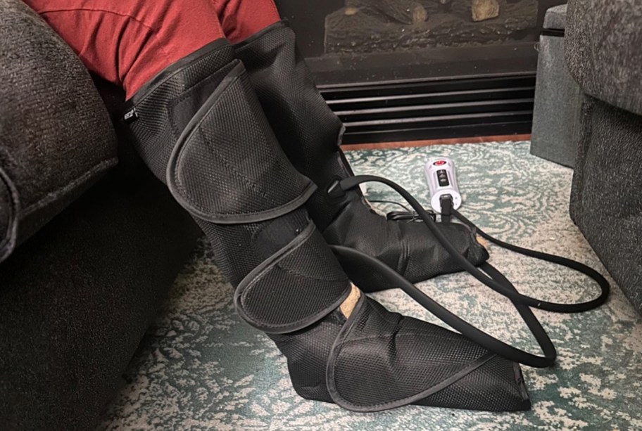 person wearing leg massager boots