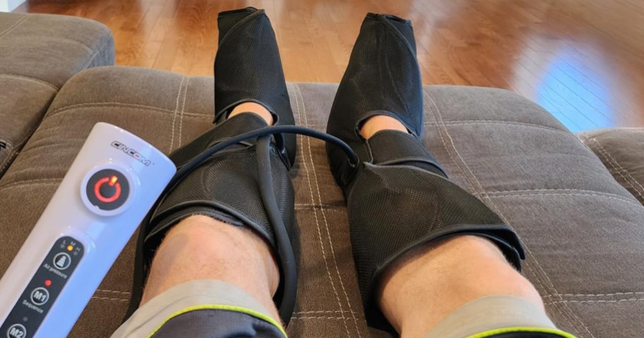 person sitting with leg massager