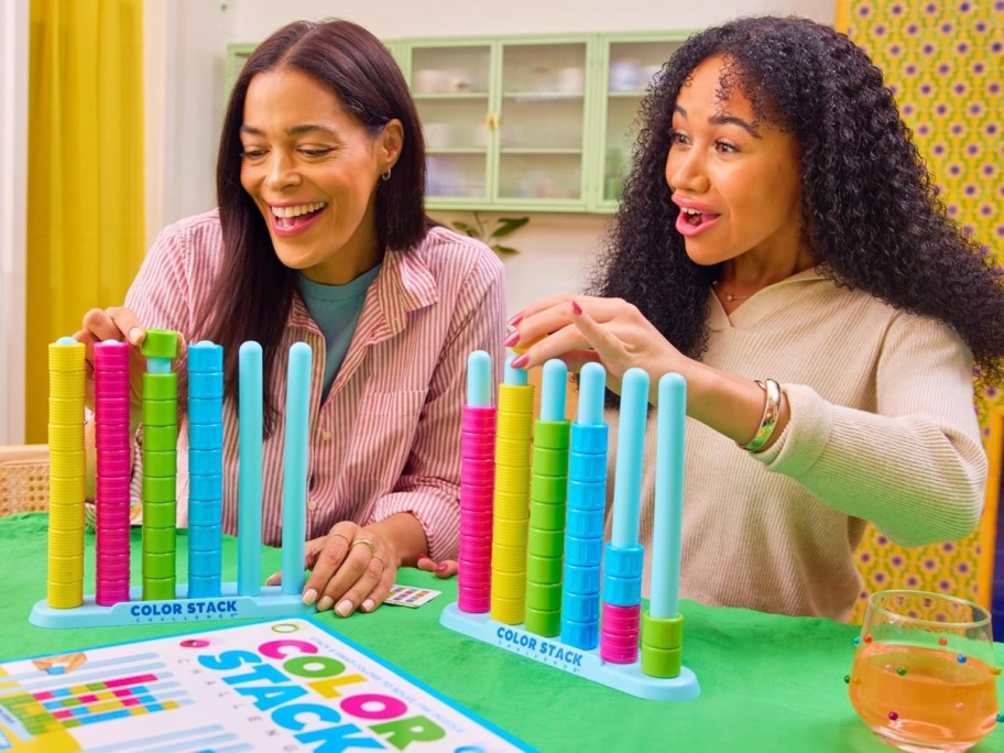 mother and daughter playing a colorful tabletop game