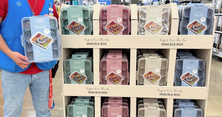 walmart employee standing next to a cook with color snackle box display