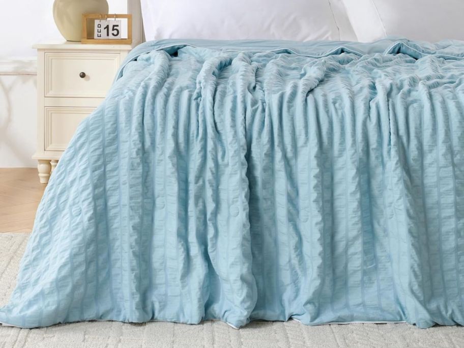 blue cooling blanket on bed