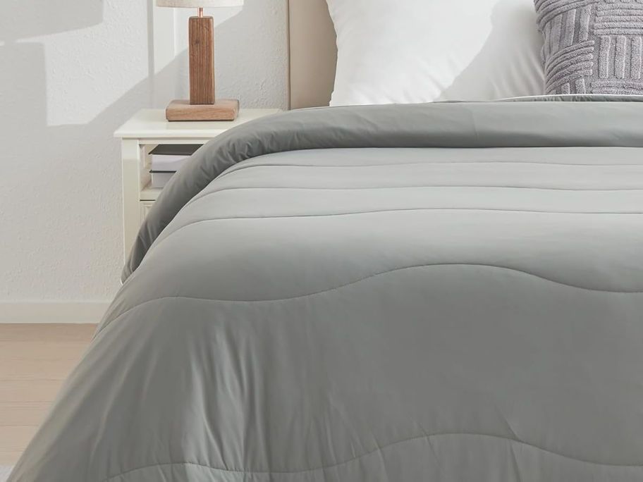 grey cooling blanket on bed