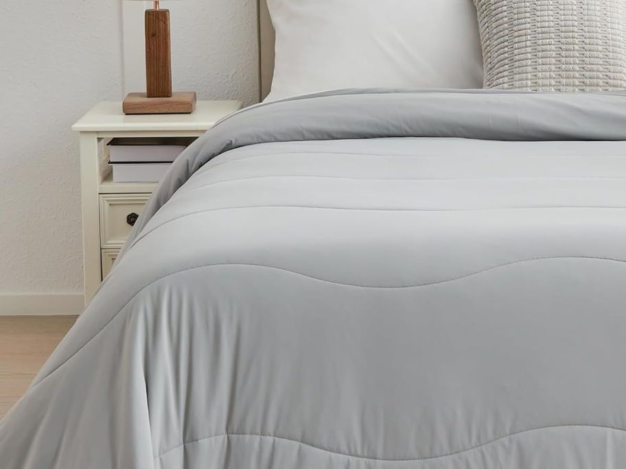 grey cooling blanket on bed