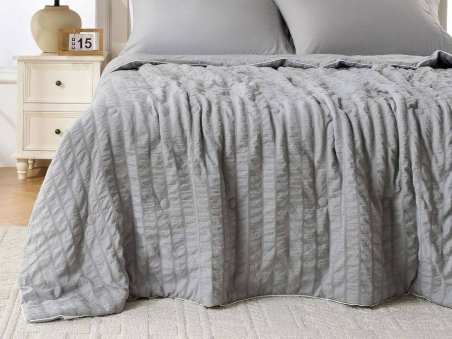grey cooling blanket on bed