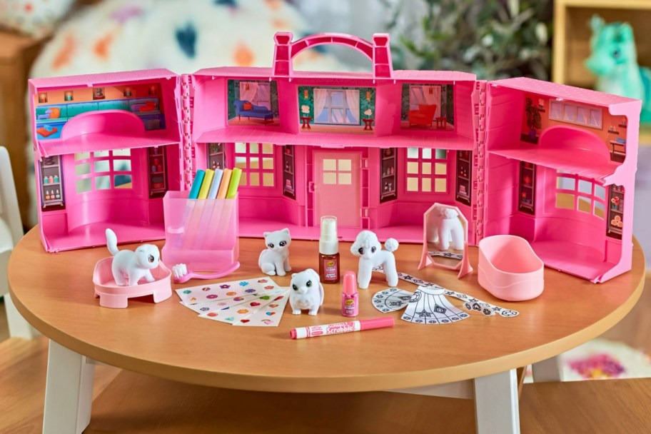 pet figures in front of pink playset