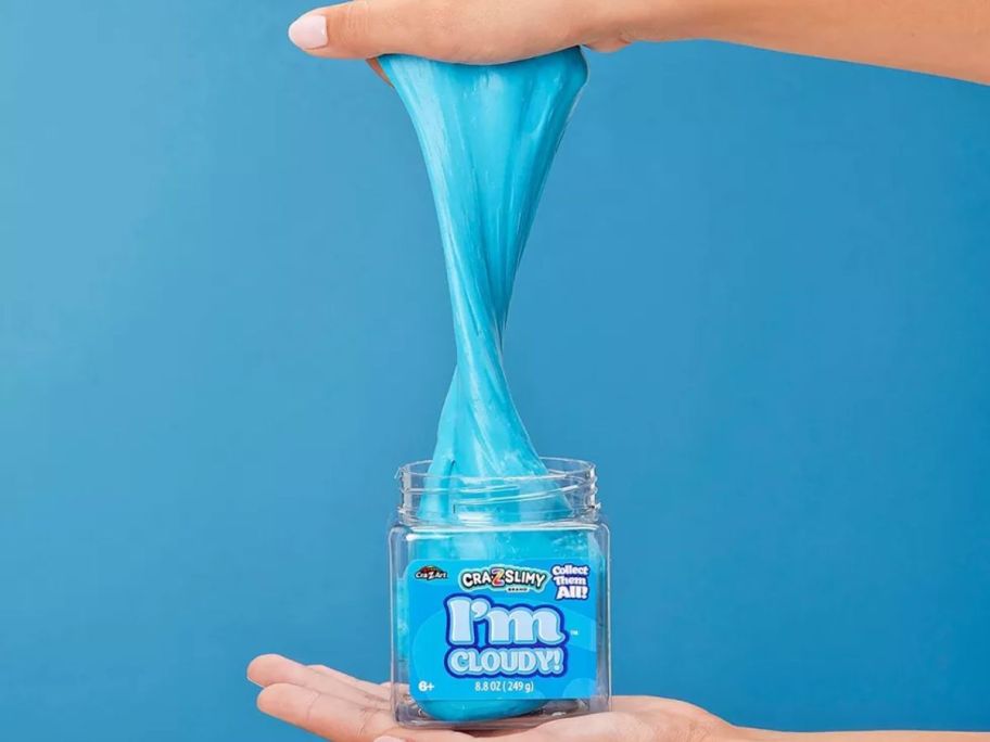 hand holding craz slimy in blue cloud