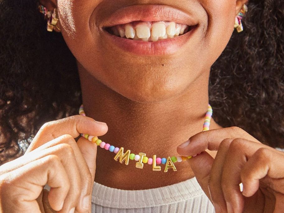 hand holding custom kids name necklace