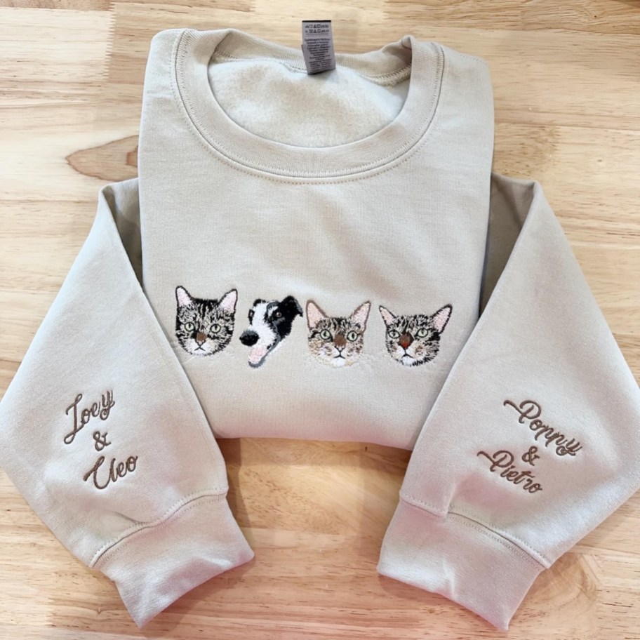 Beige sweatshirt with custom pet portraits embroidered on front