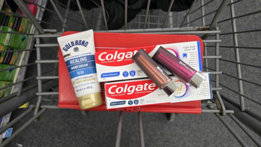 gold bond lotion, colgate toothpaste and maybelline lipstick displayed in a cvs cart basket