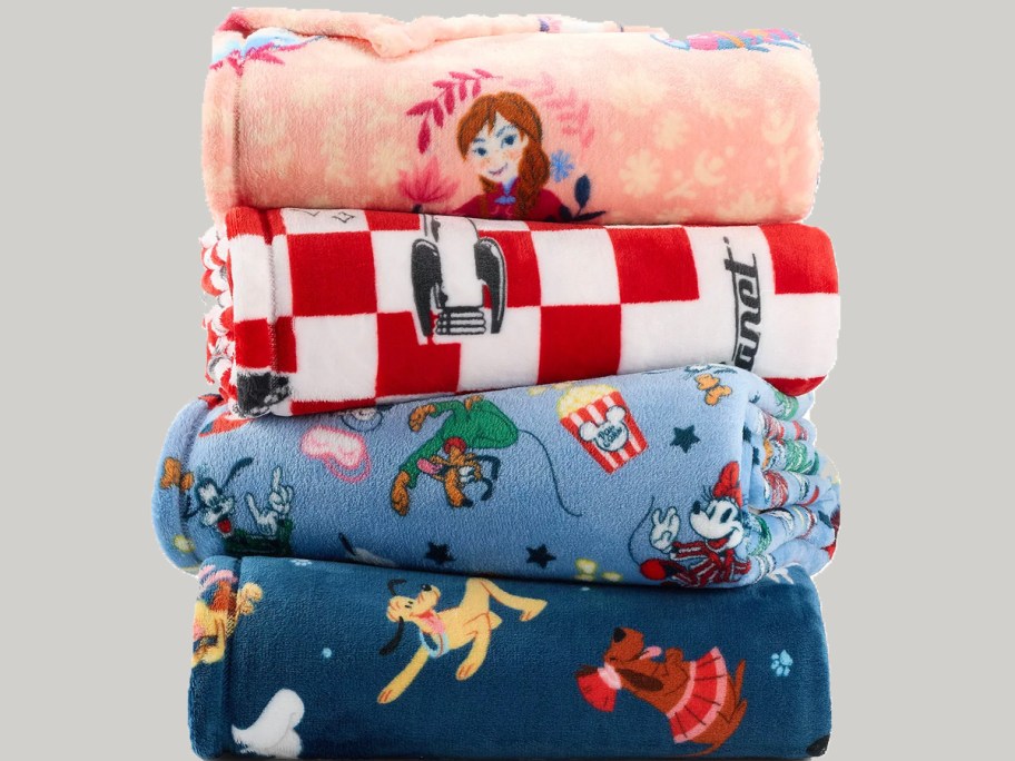 4 disney blankets stacked 