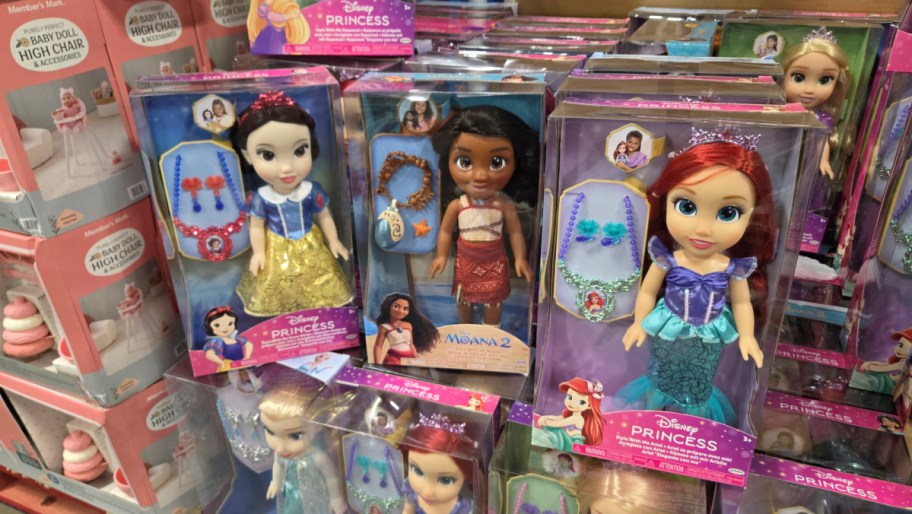 disney princess dolls in boxes on display in a store