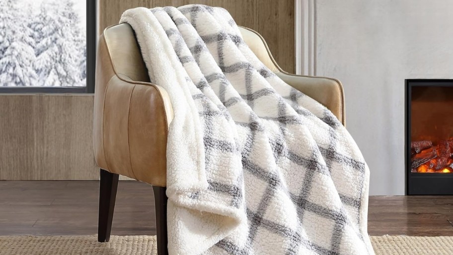 beige and black pliad eddie bauer throw draped over a chair