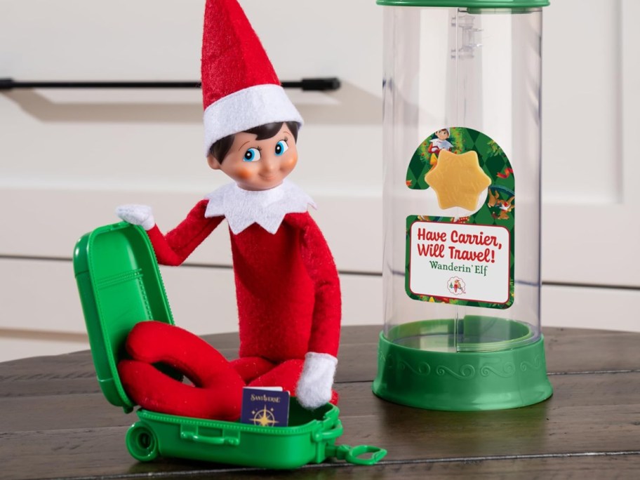 elf on the shelf in a toy suitcase with travel accessories