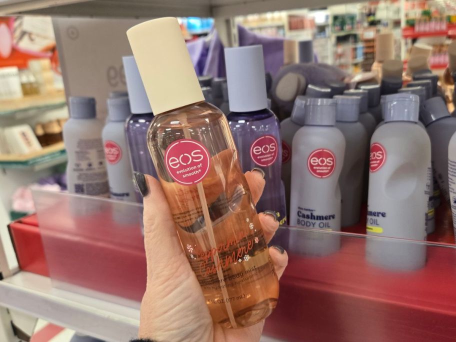 hand holding eos holiday body mist in Peppermint Cashmere in store