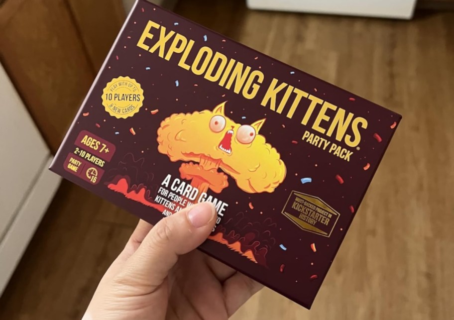 hand holding exploding kittens card game