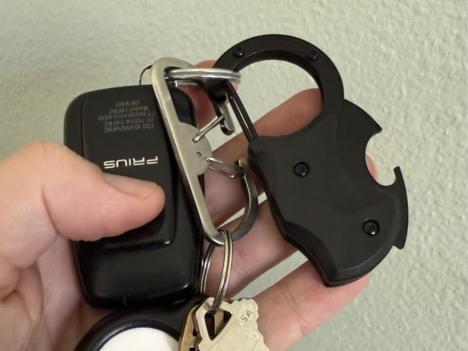 folding knife keychain with keys attached in hand