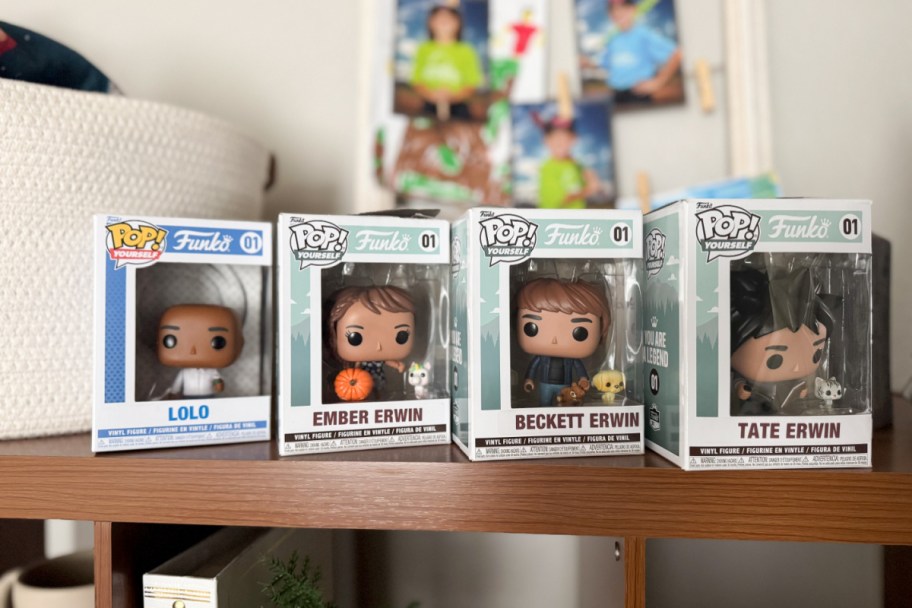 four custom funko pop characters in boxes lined up