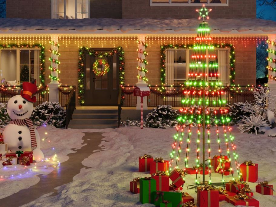 Govee 7.5' LED Multi-Function Color Changing Cone Tree Lights on front lawn