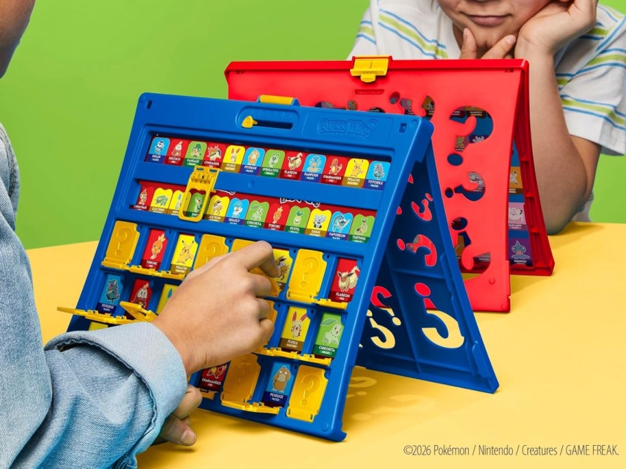 two children playing pokemon guess who game