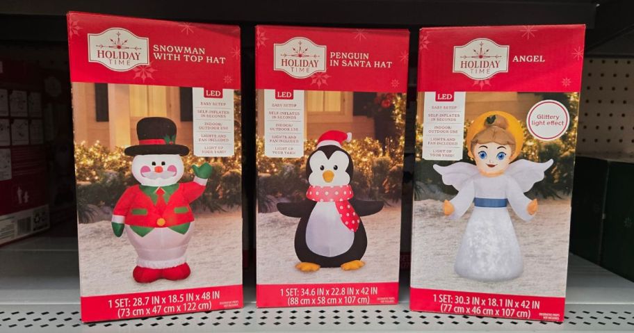 three holiday time christmas inflatable boxes on shelf in store