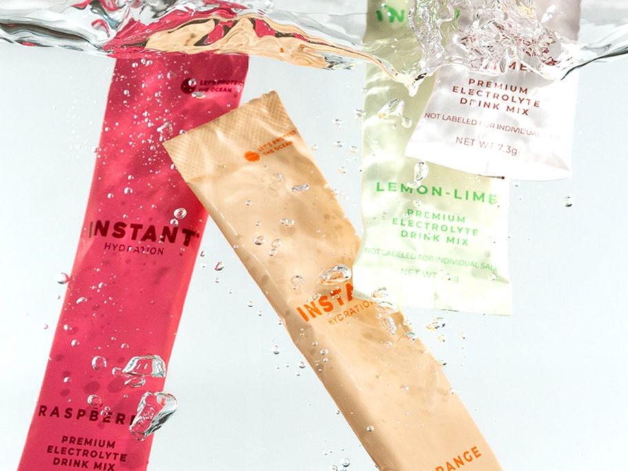 four different hydration packets in water