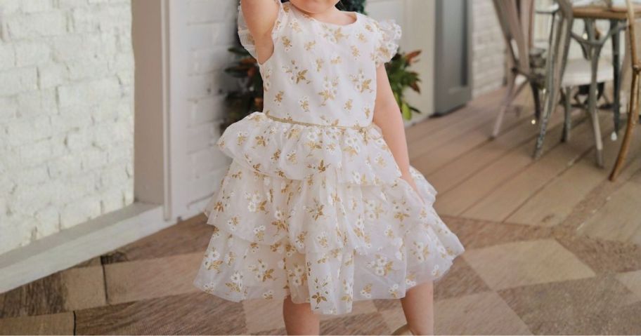 girl wearing holiday dress on porch