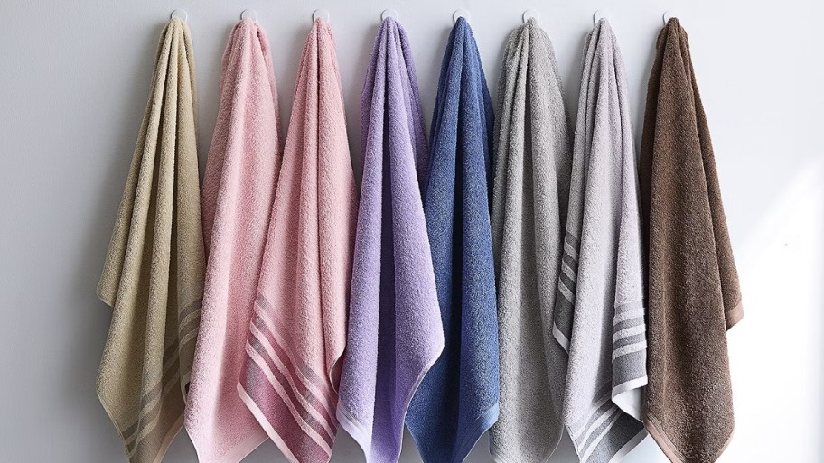 jcpenney bath towels in various colors hanging on hooks