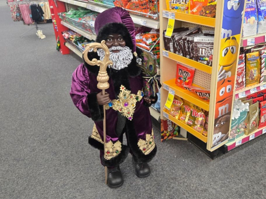 Joyward 34" Merry Brite Santa Holding Staff & Gifts on floor in store