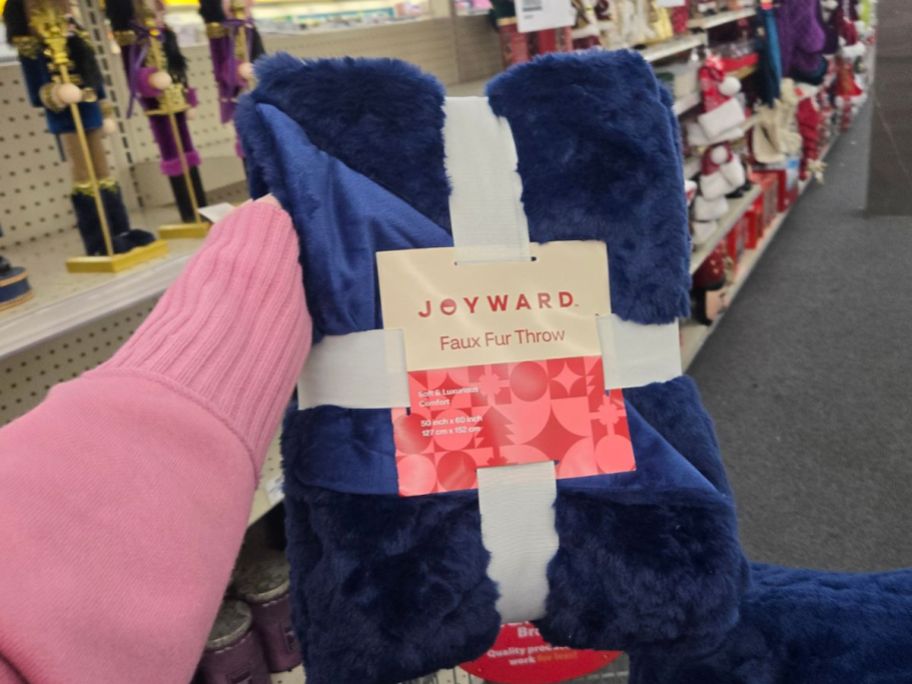 Joyward Faux Fur Navy Throw Blanket in hand in store