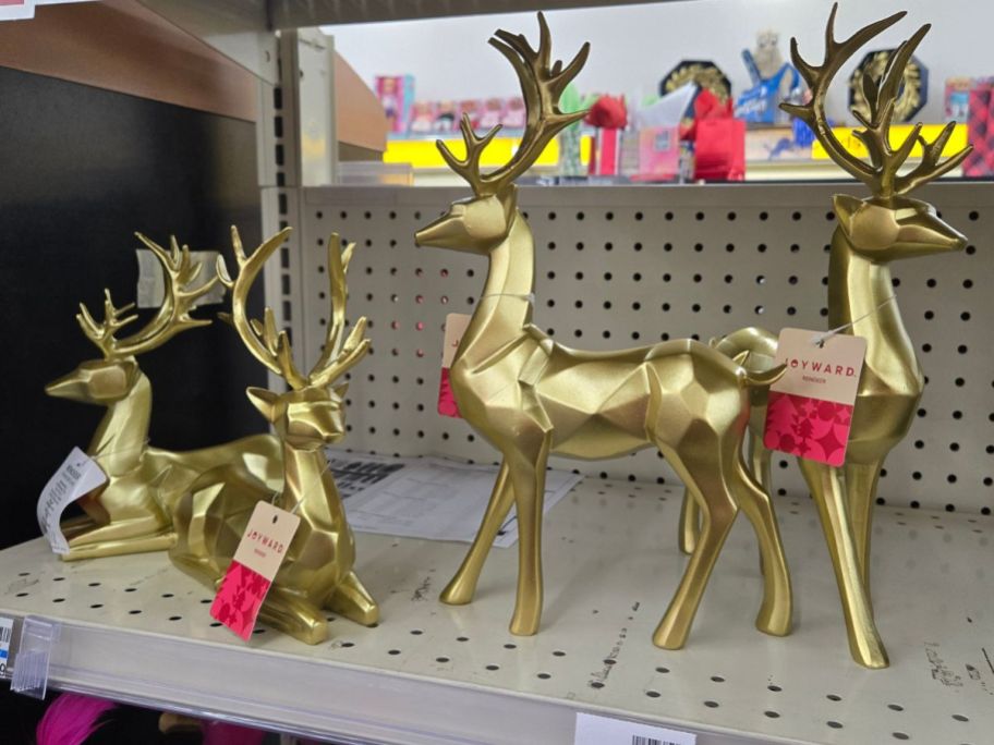 gold reindeer figurines on shelf in store